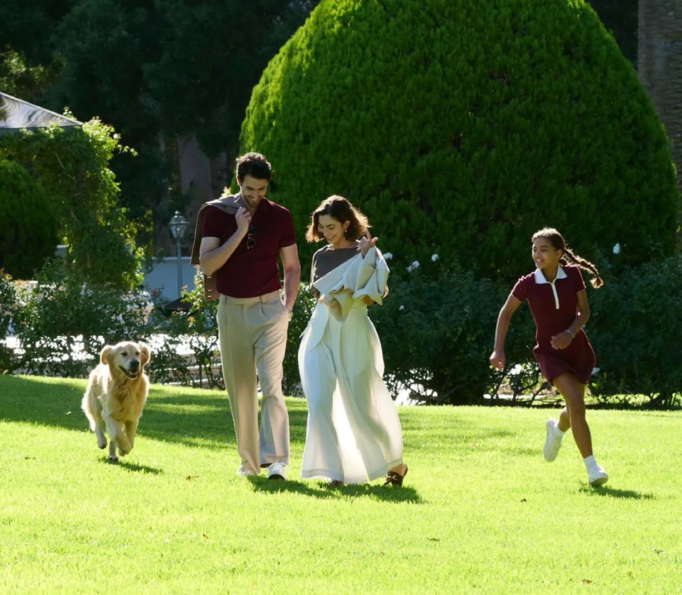 Family with dog walking the golf course lawn, official Modon render