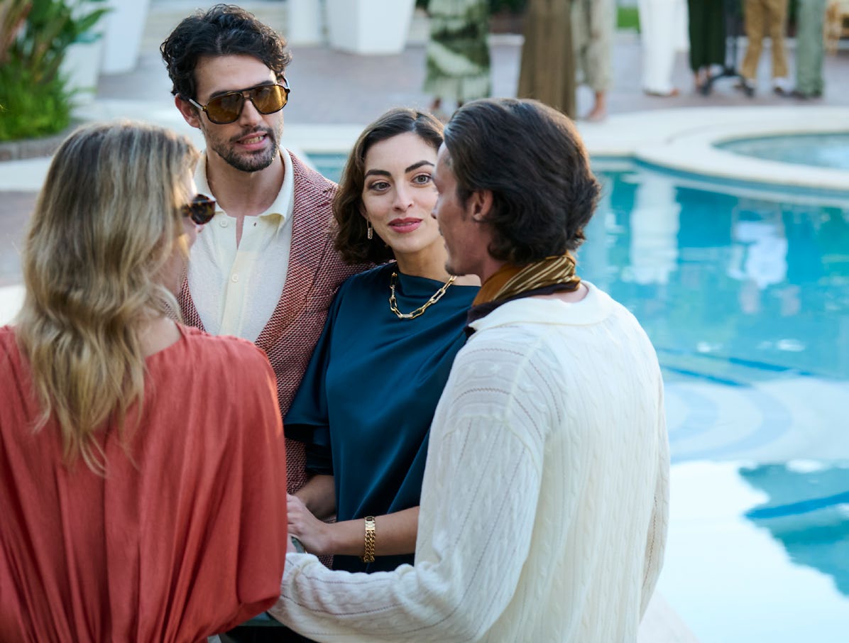 Residents socialising by the pool at Hudayriyat Golf Estates