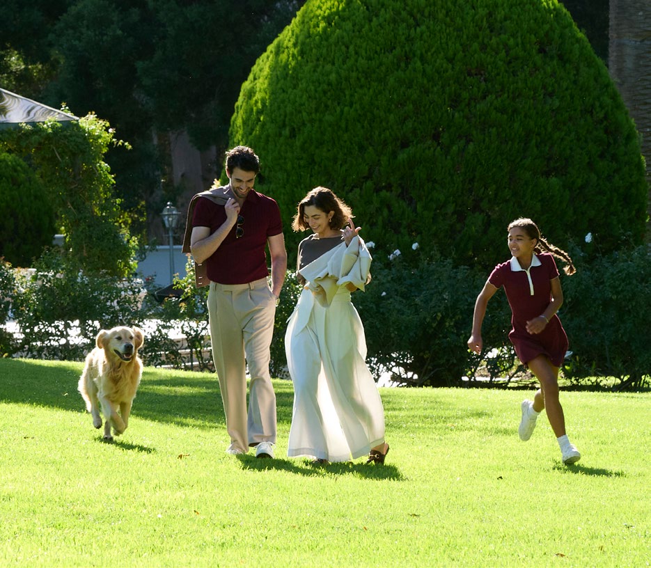 Family enjoying the green gardens at Hudayriyat Golf Estates