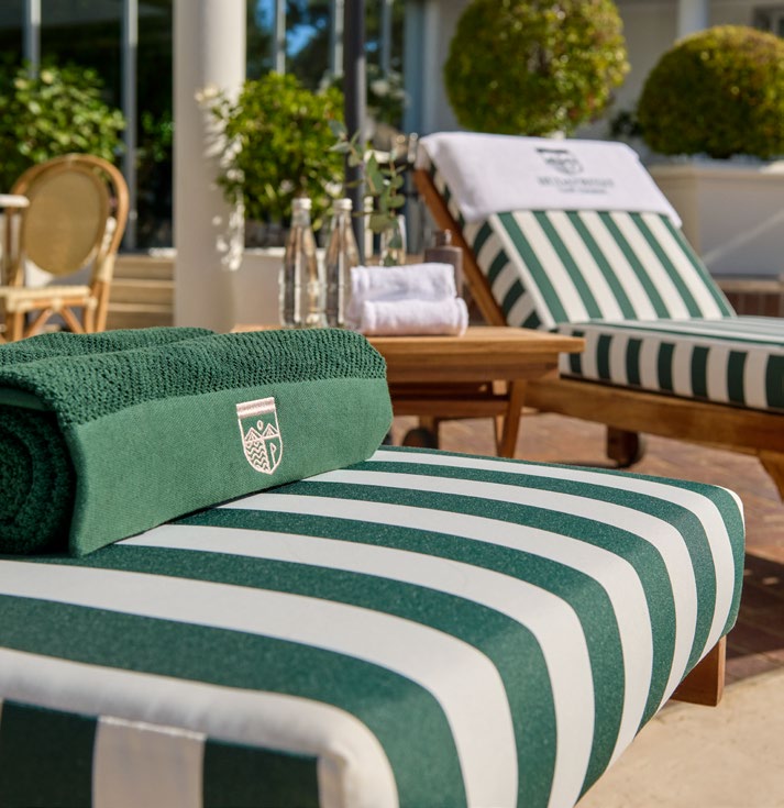 HGE branded sun lounger with signature green stripe